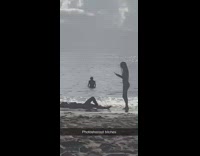 Girl Poses Laying Down on Beach Water 