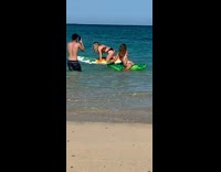 Girls pose on pool floats at beach 
