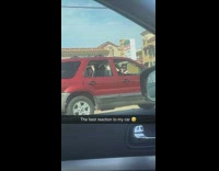 Group of guys in red car react to car revving