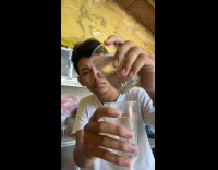 Guy tris to pour water onto glass 