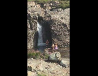 Man shirtless dip hair flip small waterfalls