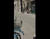 Collab IITW - Woman puts lipstick for video on sidewalk