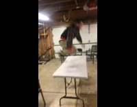 Drunk guy jumps over foldable table, breaks table in half and falls down