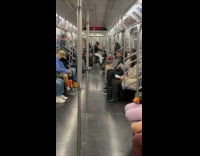 Collab Subway Creatures - Man holds up motorcycle inside the train 