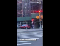 Person wears clown costume with red hair 