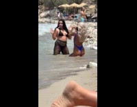 Woman black bikini poses for beach photo