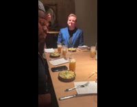 Attractive chef talks to customers on table