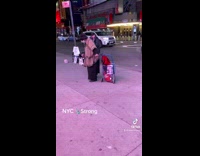 Lady and guy dance on sidewalk cart