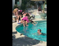 Woman in blue heels dips it in the pool