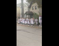 A bunch of people wearing seltzer costumes marching