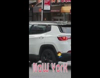 Guy cuts hair by street white car