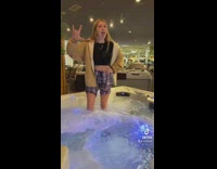 Girl in store standing inside of worming hot tub jacuzzi 