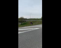 Guy rides motorcycle cross jump over freeway
