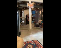 Boy jumps and dunks toy basketball 