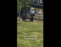 Three people practice martial arts sword park 