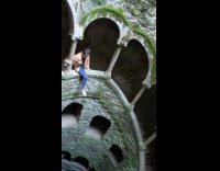 Girl sits over edge on stairs and takes picture