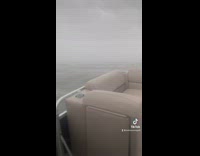 Boat in stormy ocean water flooded almost sinks