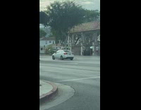Woman bikini poses near a car at the car wash