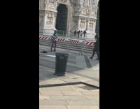 Woman in black and white checkered jacket near a Cathedral