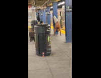 Shirtless man works out at train platform