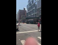 Two guys play catch in middle of street