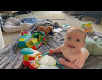 Baby lie down and plays the drums