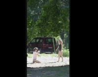 Black bathing suit girl kicks sand car