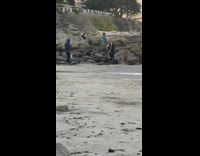 Girl denim jacket sit on rock beach