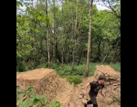 Bike guy jump over man doing backflip