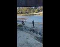 Woman raises both hands pose under the bridge
