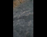 Waves from ocean splashed to woman filming