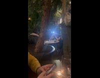 Woman takes picture with flash inside restaurant