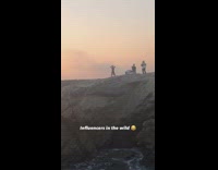 Black leggings girl dances rock ocean sunset 