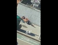 Shirtless guy lays sidewalk sixty four degrees 