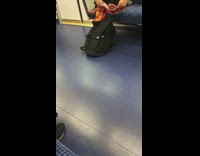man on train cleaning feet with red towel