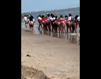 Group of women lined up twerk beach