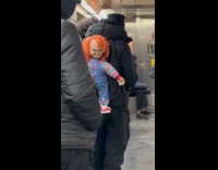 Guy rides subway with chucky on back