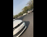 guy riding bike gets hits by car and falls over