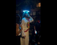Jesus stands on street after Halloween parade