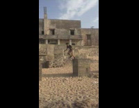 Guy on concrete block jumps falls sand 