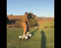 Guy hits golf ball club breaks hoverboard 
