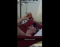 Man pours drink selfie video shoot red hammock