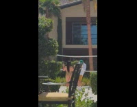 Woman in green bikini poses at the volleyball net