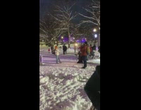 Woman orange bonnet sweater Christmas lights snow Part 1