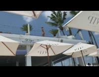 Woman black bikini bar rooftop white umbrella