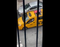 Taxi driver drives with foot on window