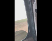 Car drives by a tornado grass field 