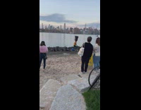 Man rides on bike and carry water tank at park 