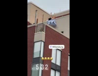 Shirtless DJ plays party music at rooftop