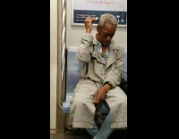 Man combs hair with white spork and throws hairs on subway floor